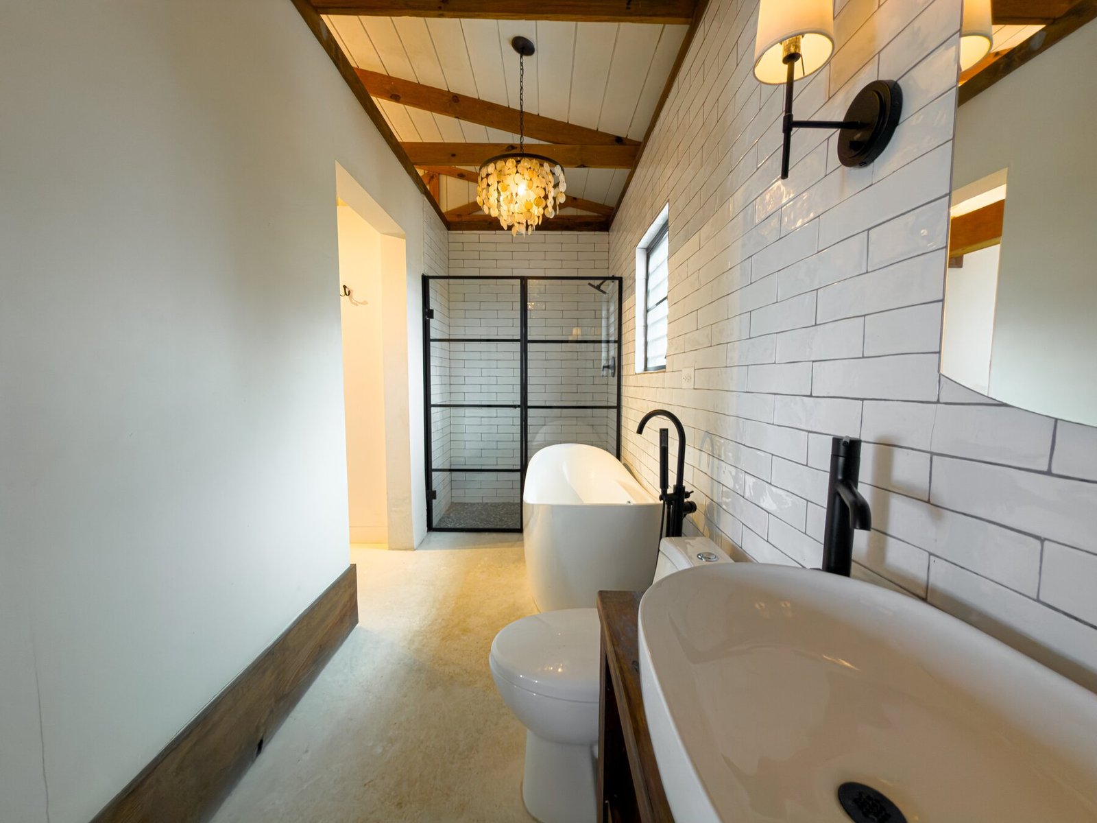 View down the bathroom corridor toward the shower and vanity