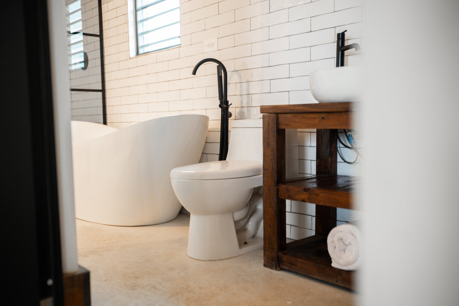 View through the doorway to the tub, toilet, and vanity