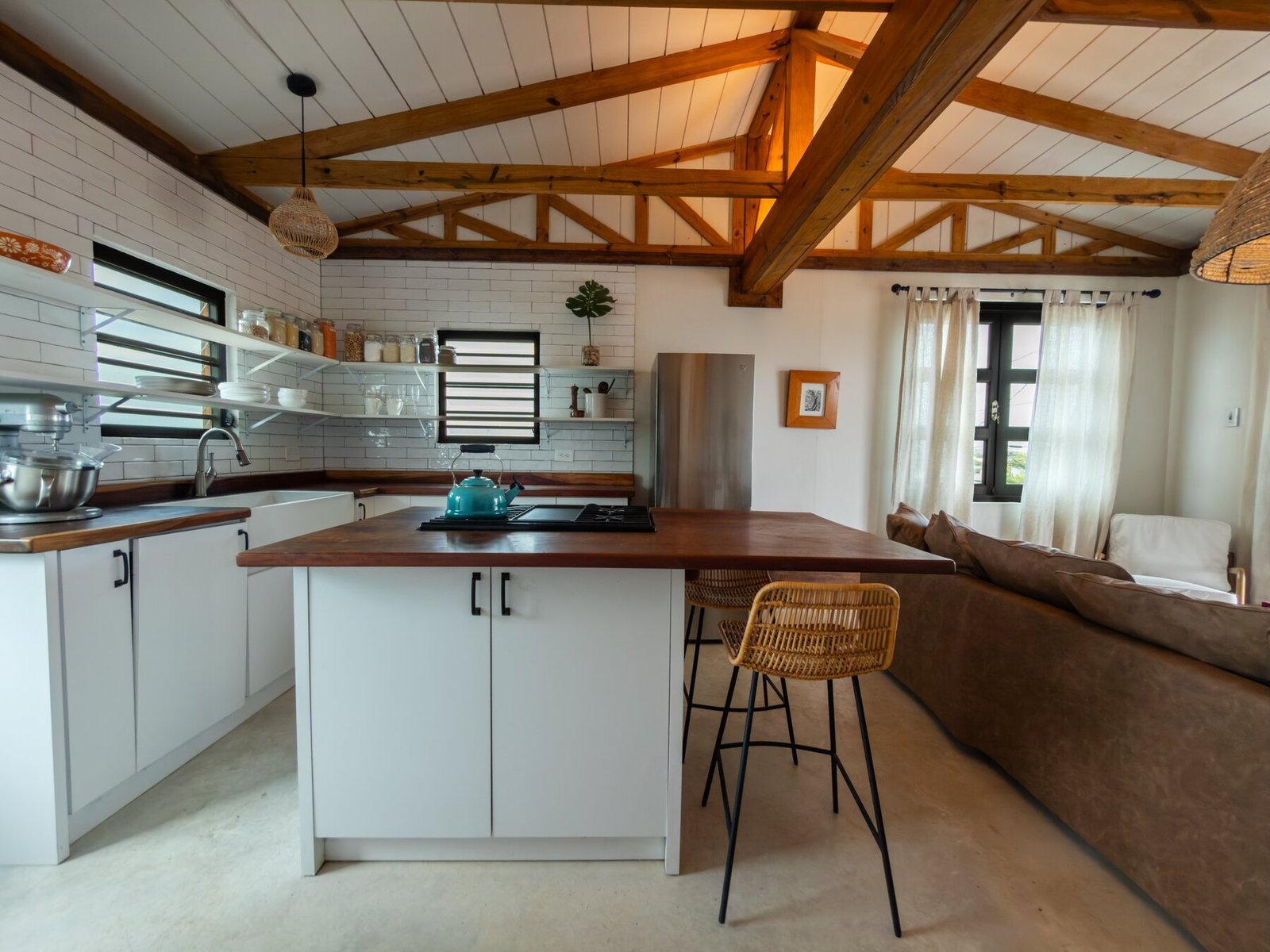 Kitchen island with butcher block counter and teal tea kettle