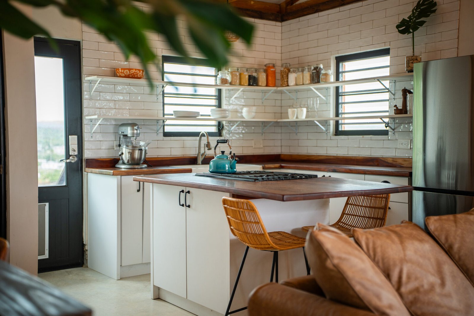 Remodeled penthouse kitchen with subway tile and open shelving