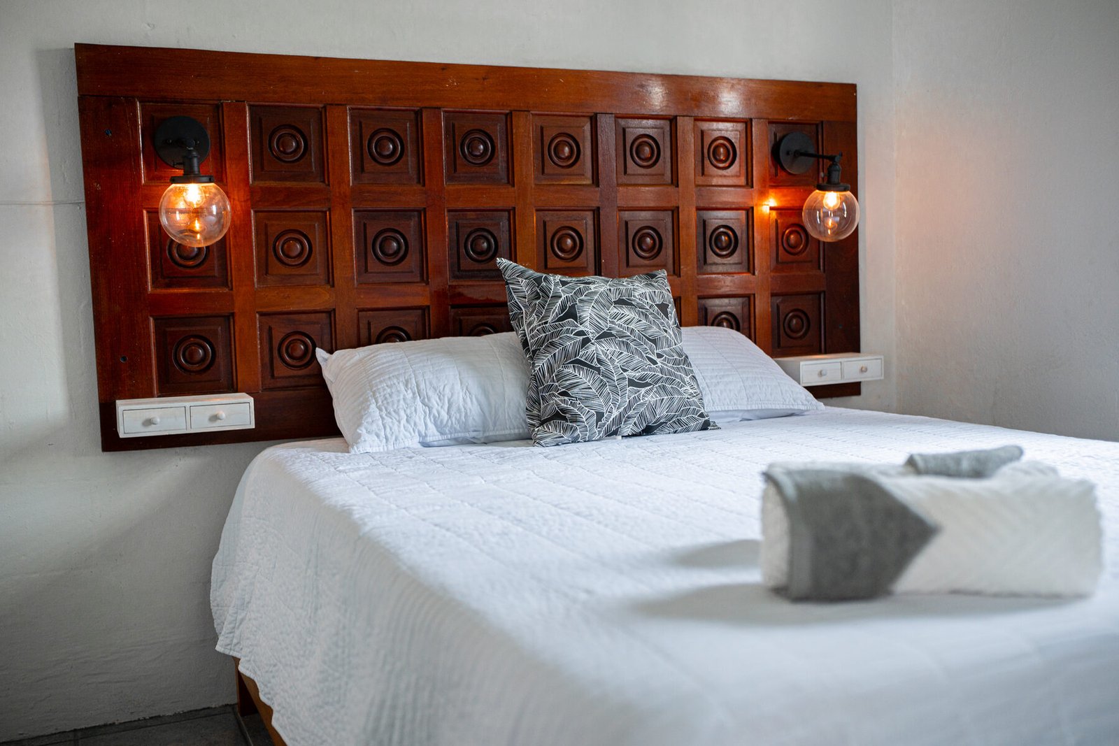 Carved wood headboard detail, lights on