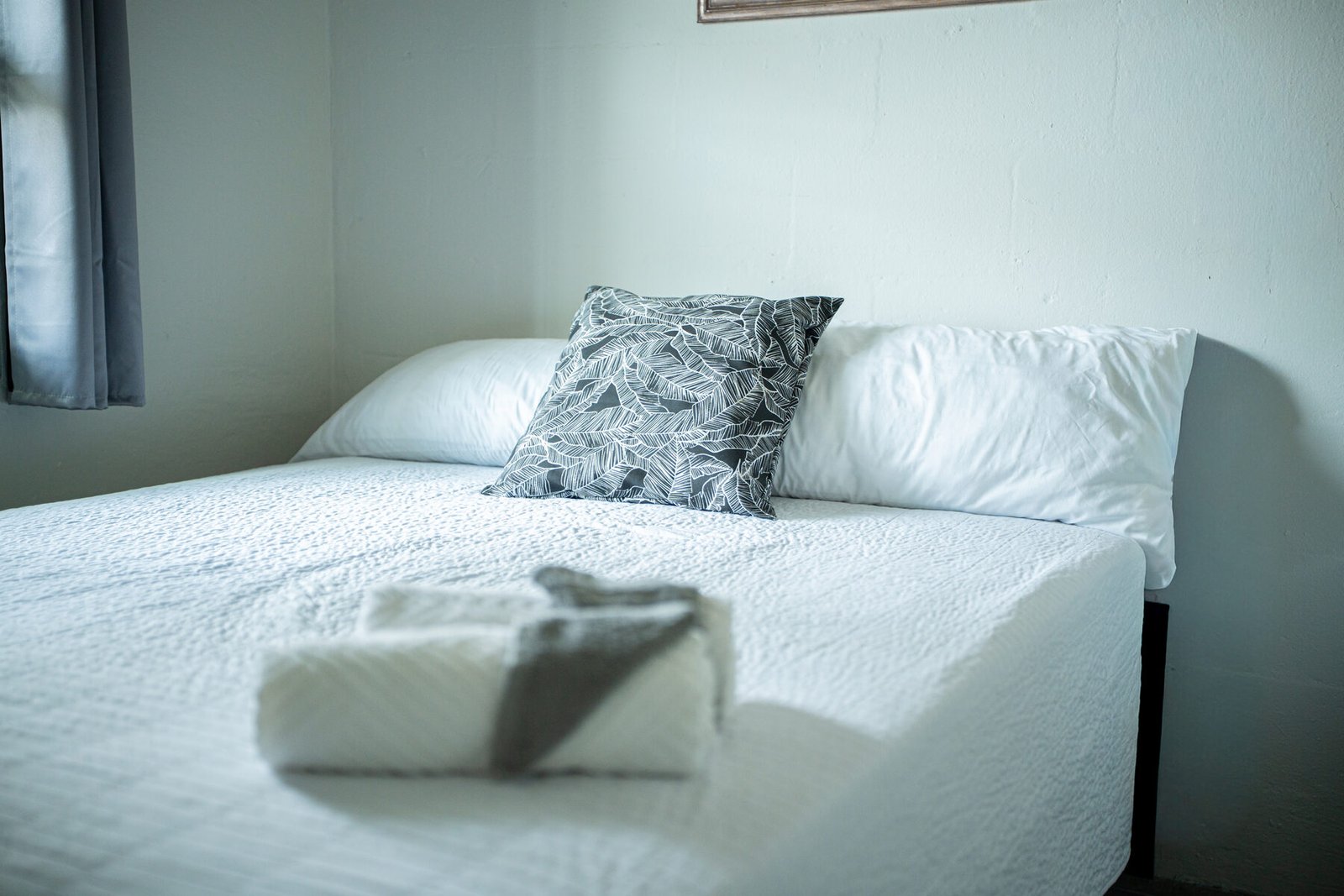 Bed detail with folded towels