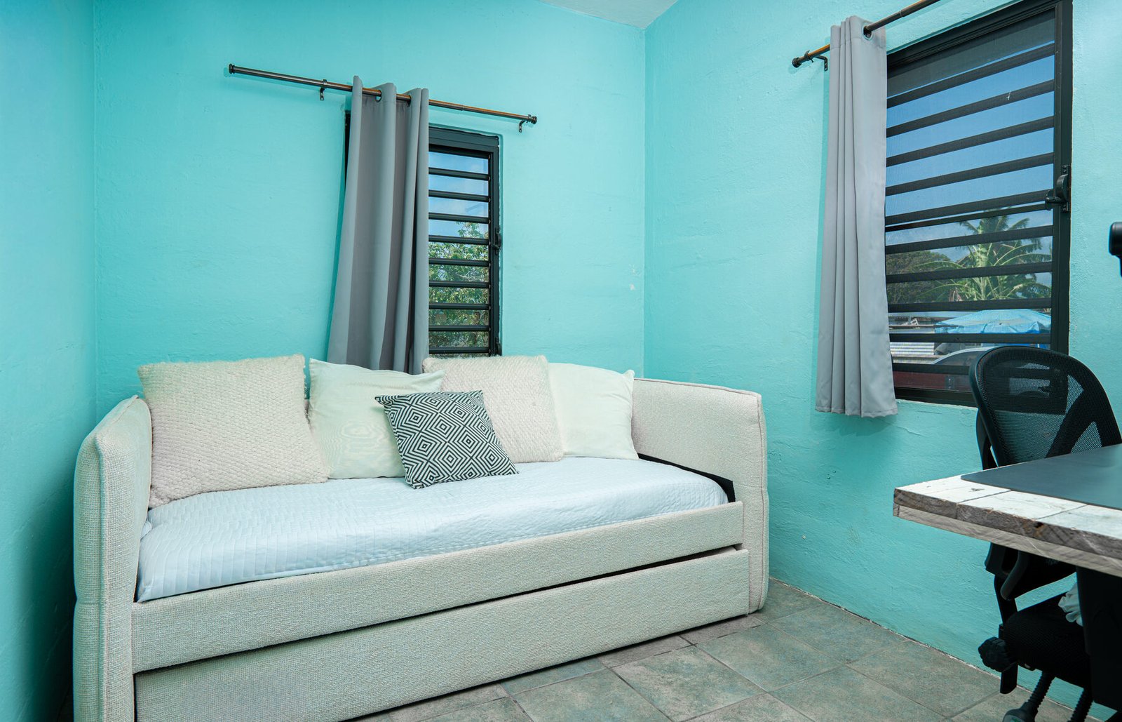 Teal daybed room with desk