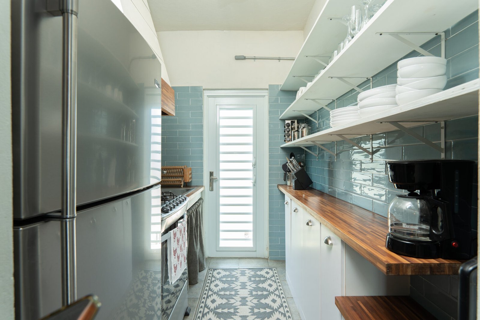 Galley kitchen view toward the exterior door