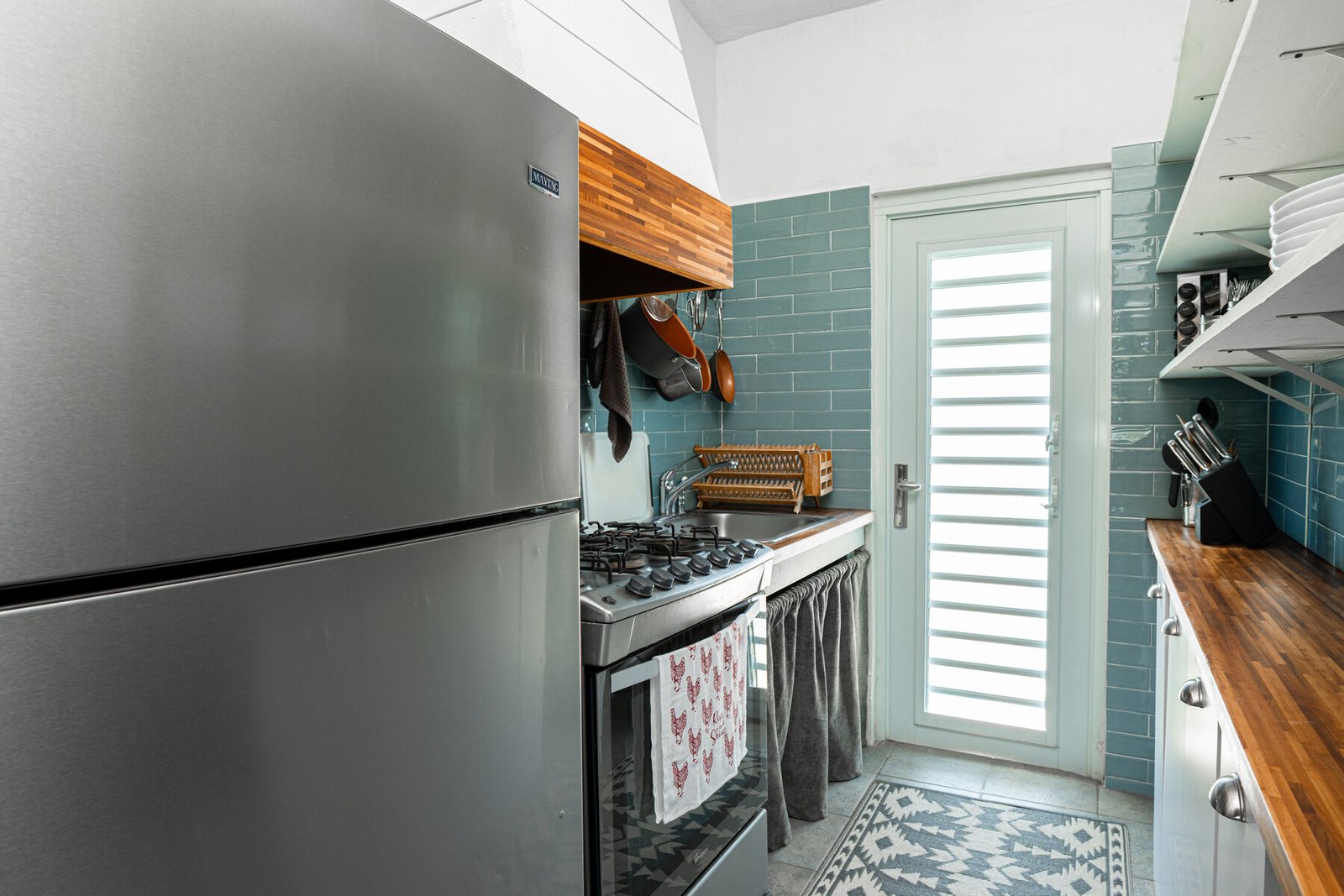 Casita Blanca kitchen with teal tile and stainless fridge