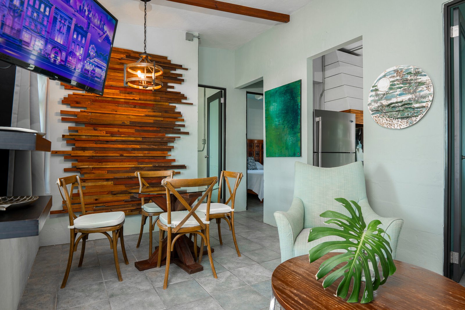 Living and dining area with wood-slat accent wall