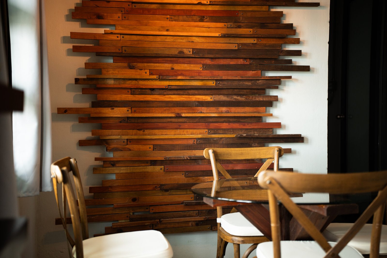 Wood-slat accent wall and dining chairs
