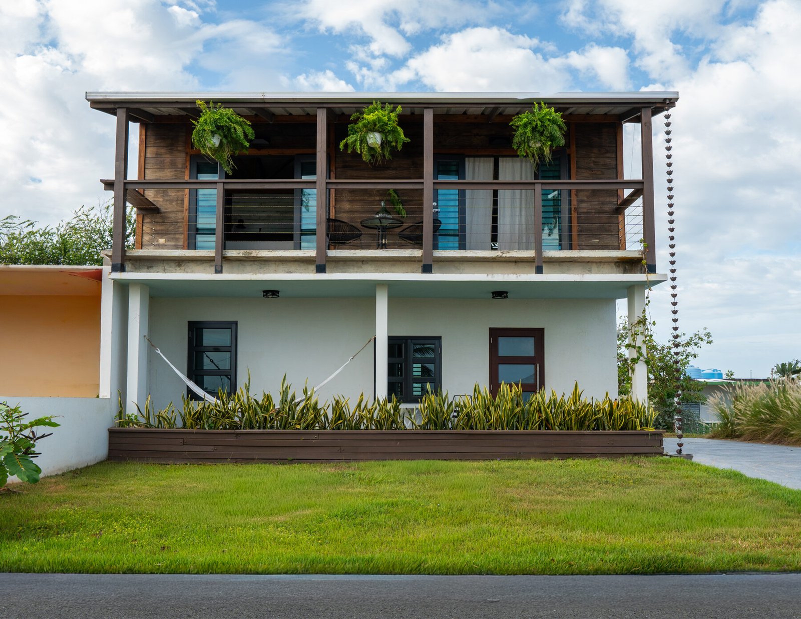 Rear exterior with wood siding and stairs