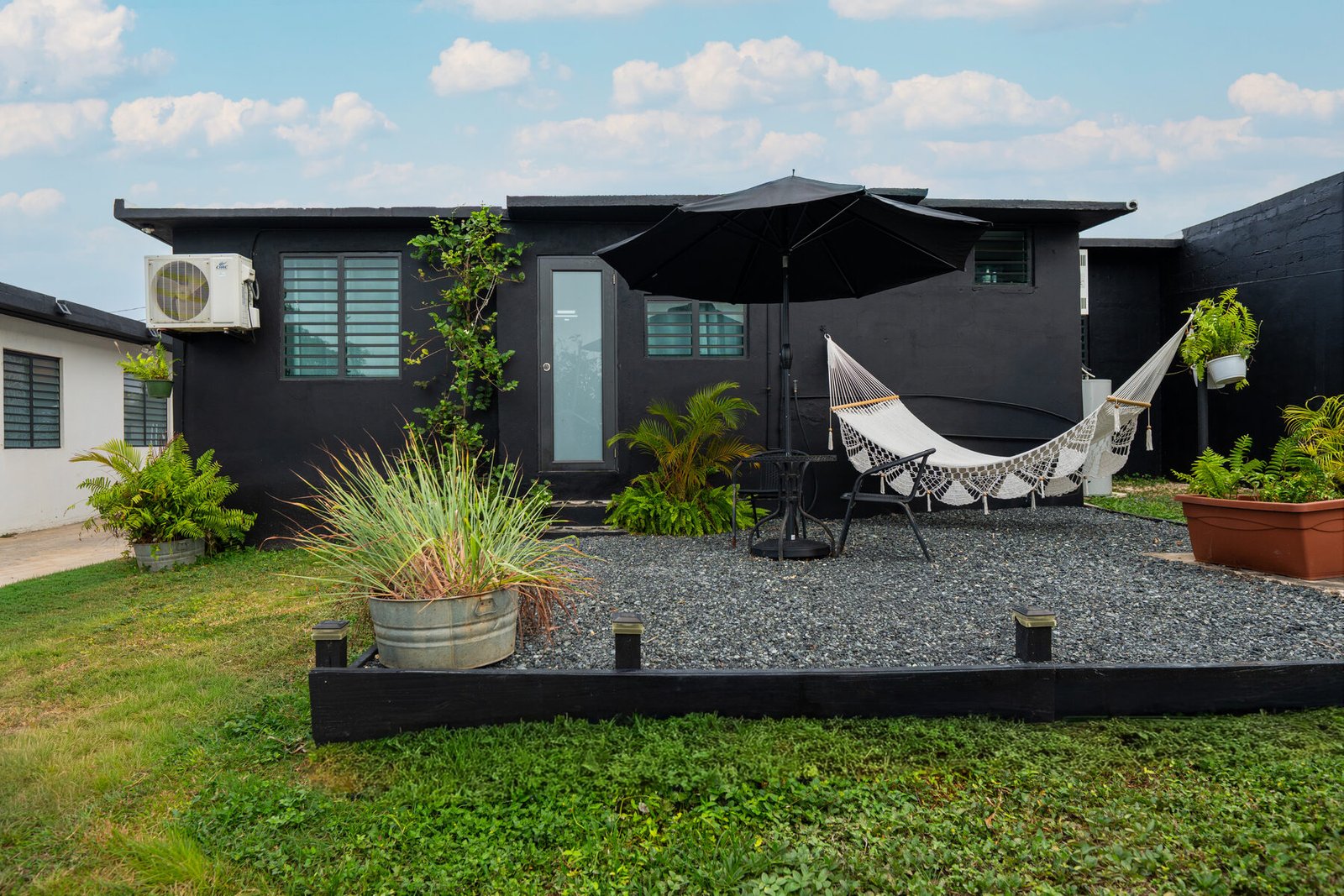 Back unit exterior patio with hammock and umbrella