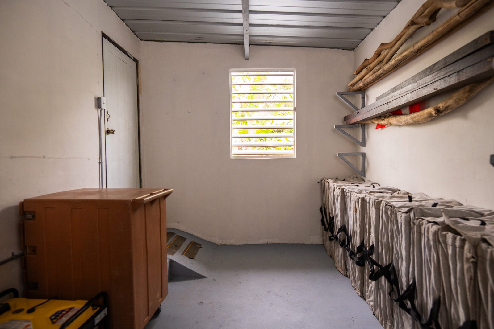 Storage room corner with driftwood and bins