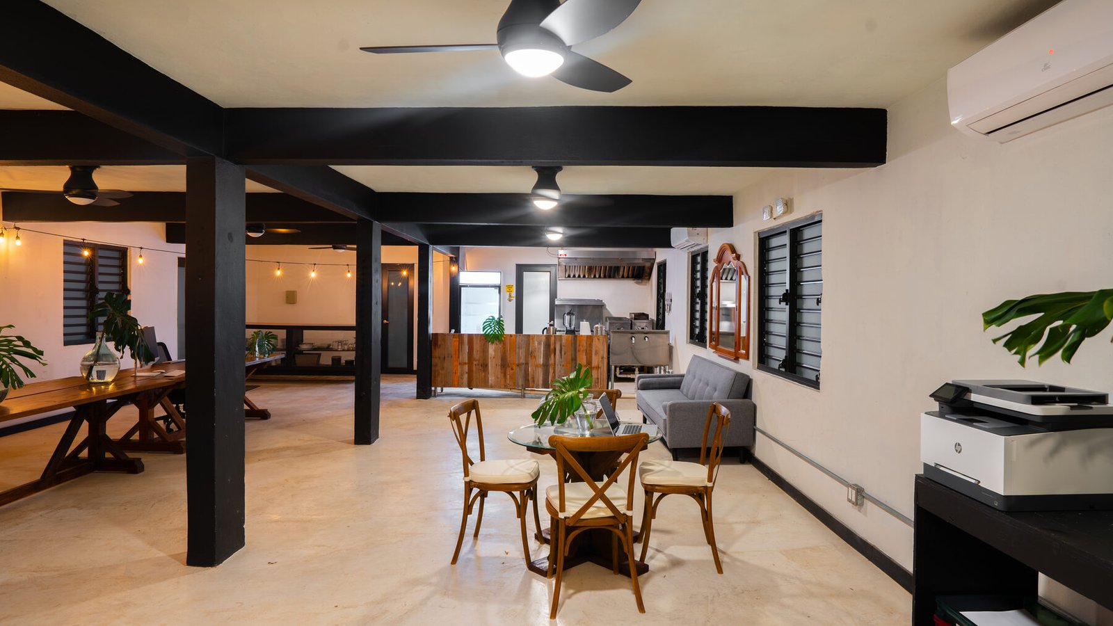 Desks and lounge seating under exposed black beams