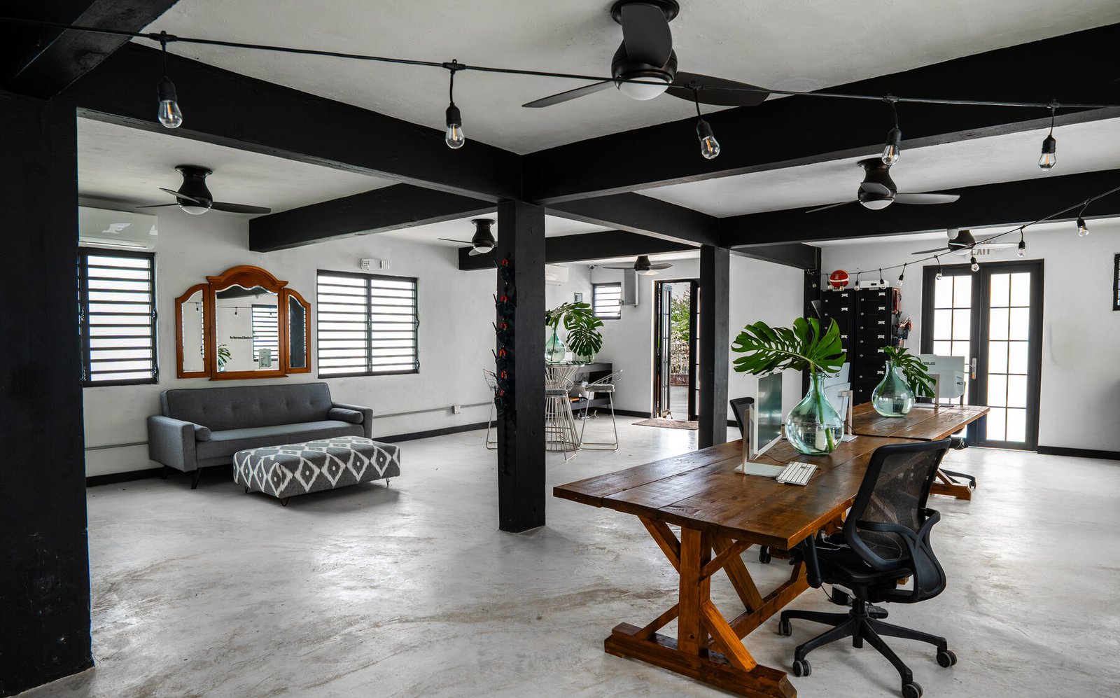 Open multipurpose room with lounge seating and desks